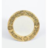 A 'Glasgow School' brass wall mirror in the manner of Margaret Gilmour, circular form, stamped in