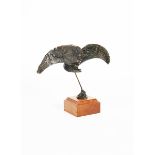 A patinated bronze sculpture of a flying bird, on square wooden base, indistinct monogram to base,