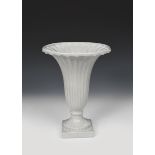 A The Fulham Pottery flower urn, model FLA1, footed, flaring fluted form, covered in a grey glaze