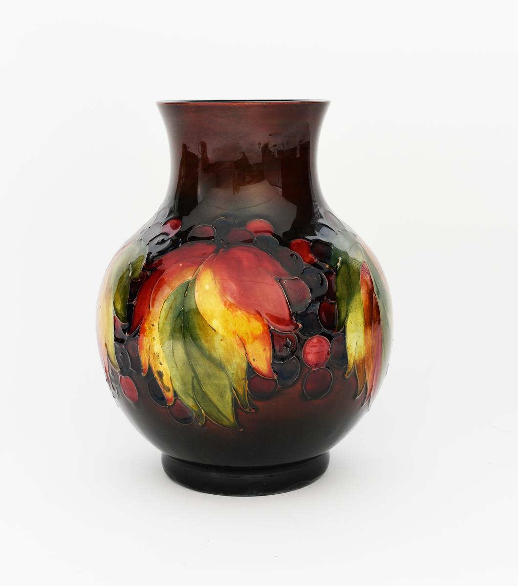 'Flambe Leaf and Berries' a Moorcroft Pottery vase, ovoid with cylindrical neck, painted in