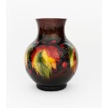 'Flambe Leaf and Berries' a Moorcroft Pottery vase, ovoid with cylindrical neck, painted in