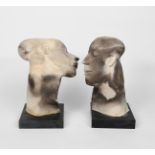 ‡Patricia Volk (born 1951) a pair of raku busts, on polished slate bases, unsigned, losses 39cm.