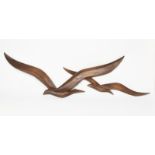 An American patinated bakelite wall sculpture, modelled as two flying stylised birds, cast marks
