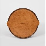 A John Makepeace burr walnut card tray, circular with two disc handles, the rim with ebony and