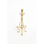 An Art Nouveau brass table lamp in the manner of WAS Benson, tripod foot, flanking central,