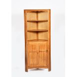 A Reynolds of Ludlow oak corner cabinet, two shelf compartment above hinged, panelled door cupboard,