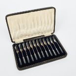 A set of twelve Liberty & Co silver and enamel cake forks, the terminals enamelled with a stylised