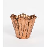 A WAS Benson copper jardiniere, the flaring body comprising six petals with rivet joints,