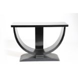 An ebonised wood console table, the rectangular top on D shaped support and tapering rectangular