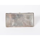 An Omar Ramsden silver cigarette case, rectangular, the case with simple geometric decoration,