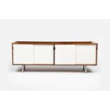 A Knoll walnut and white laminate credenza designed by Florence Knoll, the walnut frame with white