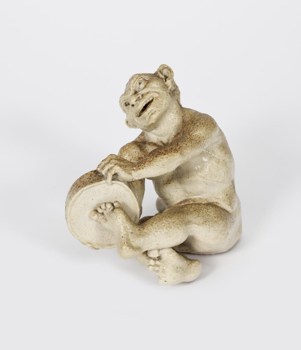 A Martin Brothers stoneware Imp Musician by Robert Wallace Martin, dated 1910, modelled seated