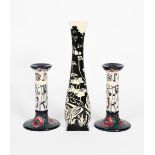 'Charles Rennie Mackintosh' a pair of Moorcroft Pottery candlesticks, painted in colours, and a