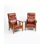 A pair of Liberty & Co oak reclining armchairs, the arms with simple carved slat support, with