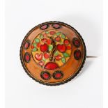 A rare Arts and Crafts enamelled brooch by Frederick Partridge, domed, circular form, enamelled