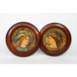 A pair of Aesthetic Movement wall panels, printed and painted with Pre-Raphaelite portraits,