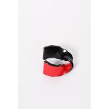 A red and black plastic bangle by Jean Marie Poinot, Paris, twisted black plastic with red front,