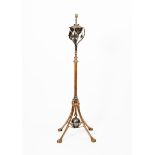 A WAS Benson copper and brass extending floor lamp, four flaring legs with claw feet, central