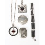 A Wege Tenn pewter pendant necklace, circular with central pink glass drop, a Logeskov pewter