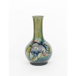 'Iris' a Moorcroft Pottery vase designed by William Moorcroft, ovoid with cylindrical neck and