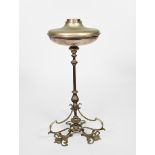 An Art Nouveau silvered metal oil lamp, flaring tripod foliate foot supporting central knopped