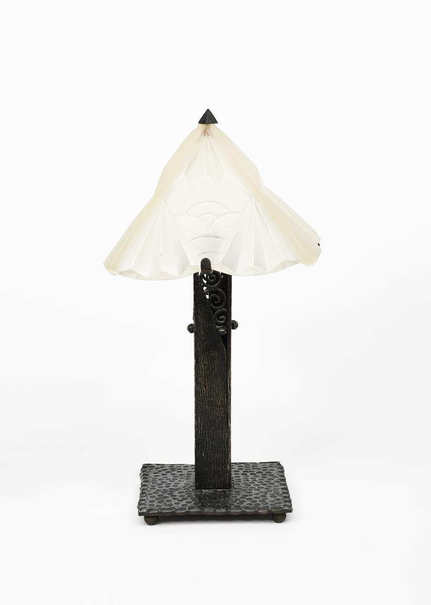 An Art Deco patinated wrought iron table lamp with Degue frosted glass shade in the manner of