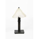 An Art Deco patinated wrought iron table lamp with Degue frosted glass shade in the manner of