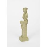 Pan a continental pottery sculpture, modelled seated on tall, slender plinth, playing his pipes,