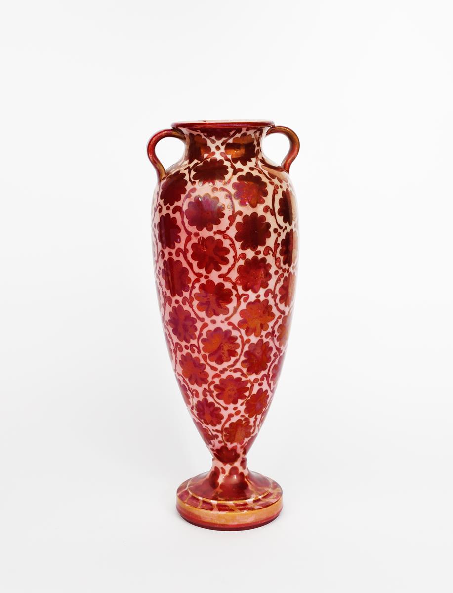 A tall twin-handled vase probably Maw & Co, slender, footed form, painted with a floral repeat in