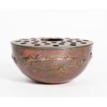 A Newlyn Industrial Classes copper rose bowl and cover, the footed rose bowl hammered in relief with