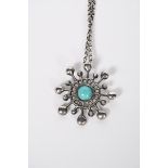 A David Anderson silver pendant necklace, cast stylised flower design with central turquoise stone