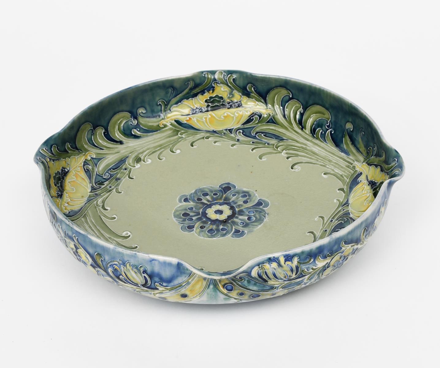 A James Macintyre & Co Florian Ware dish designed by William Moorcroft, footed, circular form with