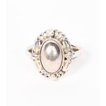 A Georg Jensen silver ring, model no.1, cast foliate band and central domed silver cabochon, stamped