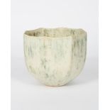 ‡John Ward (born 1938) a hand-built stoneware facetted vase, mottled green on a white ground
