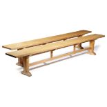 A PAIR OF OAK FORMS / BENCHES EARLY 20TH CENTURY each with a rectangular seat, on trestle ends