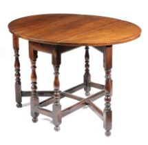 A QUEEN ANNE WALNUT GATELEG TABLE EARLY 18TH CENTURY the oval drop-leaf top on baluster and bobbin