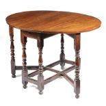 A QUEEN ANNE WALNUT GATELEG TABLE EARLY 18TH CENTURY the oval drop-leaf top on baluster and bobbin