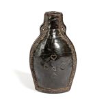 A GEORGE III LEATHER FLASK DATED '1771' of bottle form, with an open spout and pierced with two