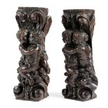 A PAIR OF OAK CORBEL FRAGMENTS 17TH CENTURY each carved with embracing cherubs, with scrolls,