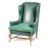 A WING ARMCHAIR IN QUEEN ANNE STYLE LATE 19TH CENTURY upholstered with studded blue leather on