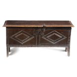 A SMALL OAK BOARDED COFFER EARLY 17TH CENTURY the lid with a moulded edge and later hinges,