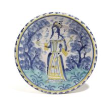 A LONDON DELFTWARE POTTERY QUEEN ANNE CHARGER ATTRIBUTED TO NORFOLK HOUSE, C.1702-14 painted in