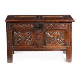 A CHARLES II OAK TWIN-PANELLED COFFER C.1660 the hinged lid revealing an interior with a lidded