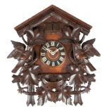 A BLACK FOREST LINDEN WOOD CUCKOO WALL CLOCK LATE 19TH CENTURY the brass eight day movement striking