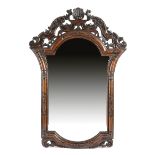 A CONTINENTAL CARVED WALNUT WALL MIRROR POSSIBLY ITALIAN, EARLY 18TH CENTURY the later shaped