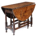A QUEEN ANNE OAK GATELEG TABLE EARLY 18TH CENTURY the oval drop-leaf top above an end frieze drawer,