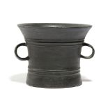 A BRONZE MORTAR 1ST HALF 17TH CENTURY crisply cast and decorated with reeded bands and with a pair
