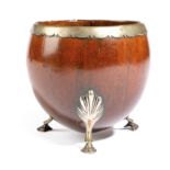 A COCONUT CUP 18TH CENTURY with an unmarked silver rim and tripod shell capped hoof feet 9.3cm