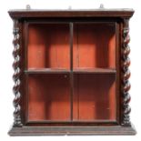 A WALNUT HANGING DISPLAY CABINET 19TH CENTURY with an astragal glazed door enclosing a red painted