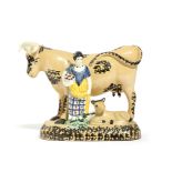 A YORKSHIRE PRATT TYPE POTTERY COW GROUP C.1810 the buff coloured bovine with sponge decoration